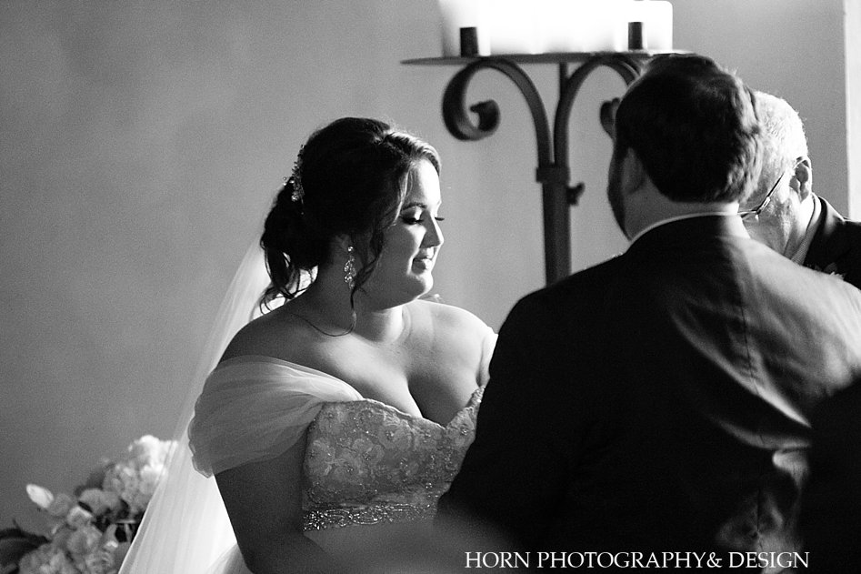 bride during vows over the shoulder black and white photo June Dahlonega Southern wedding horn photography and design