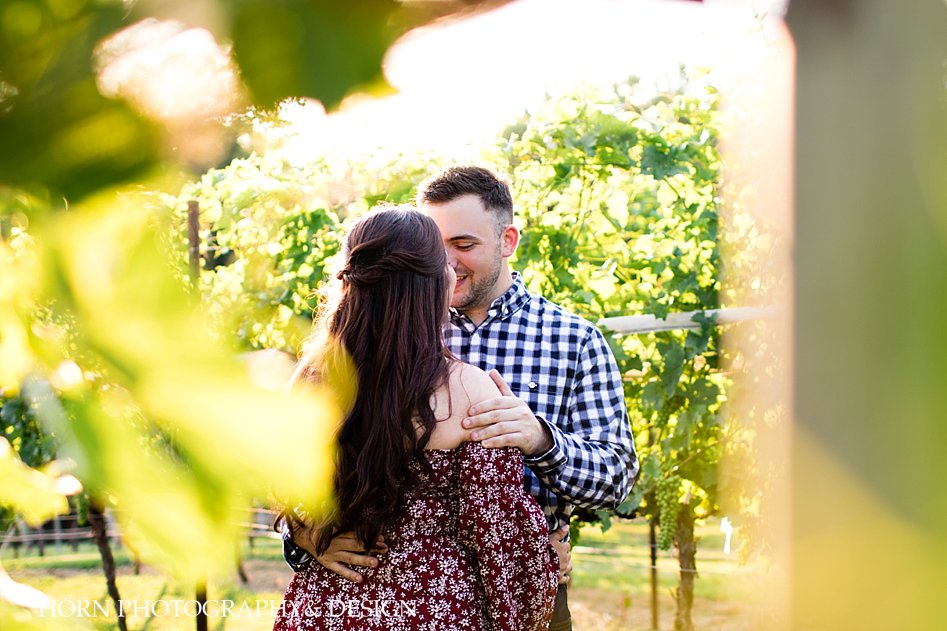 candid future husband and wife photo pose ideas long brown hair loose curls half updo red floral off the shoulder dress ATL GA horn photography and design