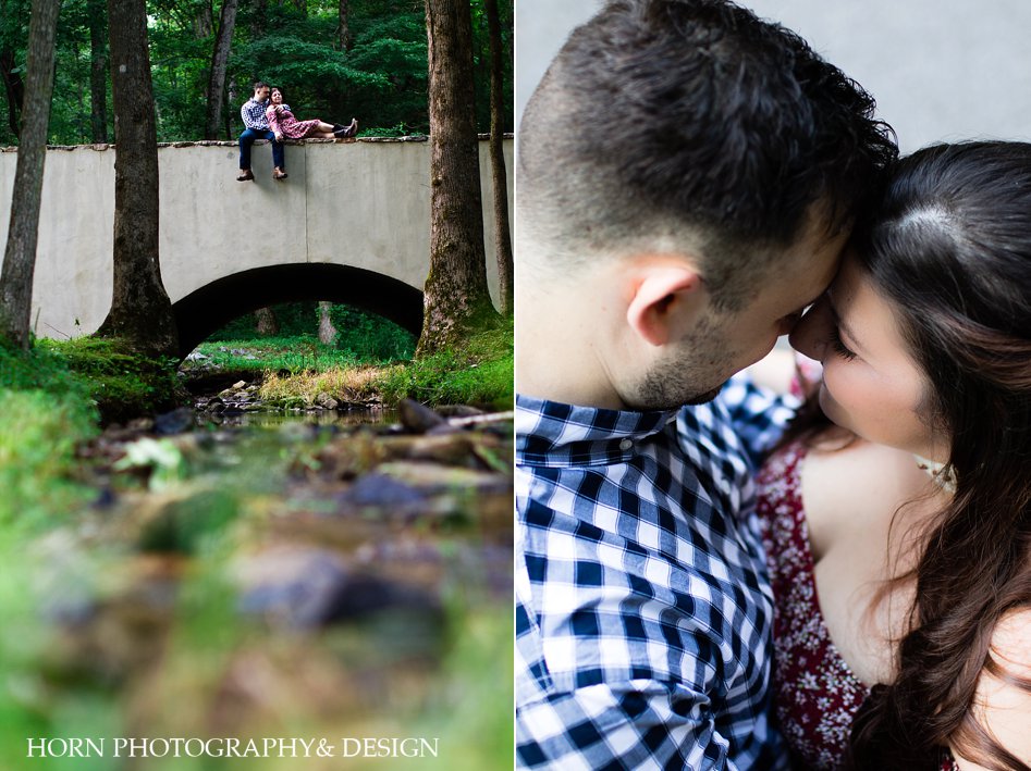couple on a bridge in wooded area overlooking river photo from above Southern Charm horn photography and design