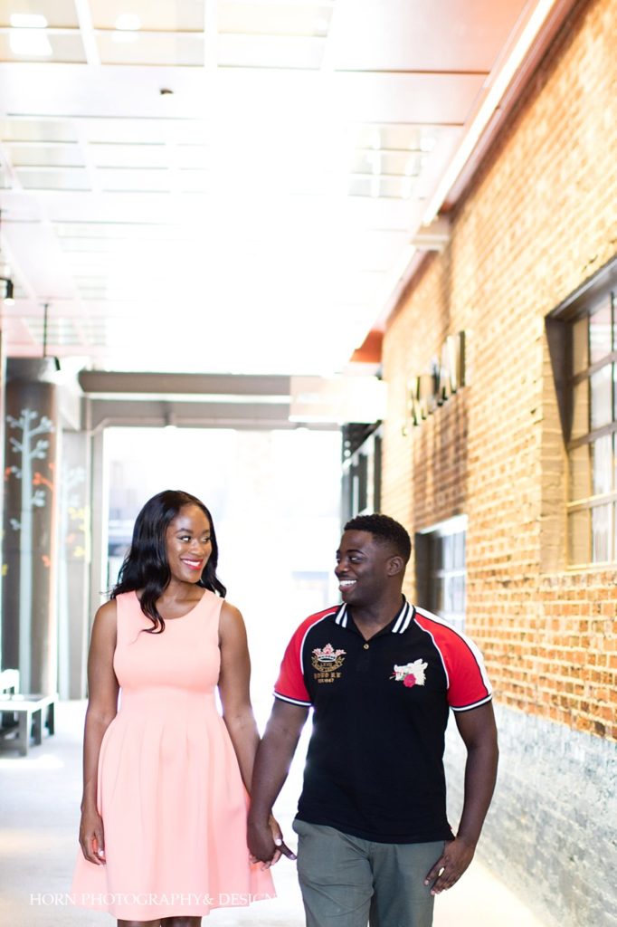 engaged couple walking holding hands Ponce City Market Atlanta Georgia high school sweethearts horn photography and design