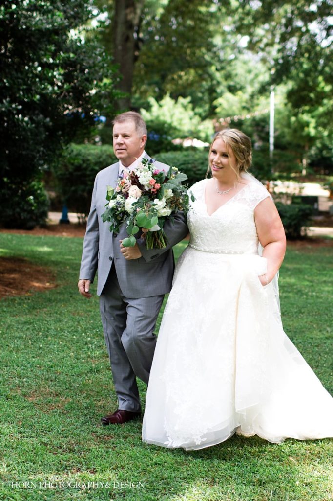 father and bride walk down the aisle lace v neck wedding dress braided updo vibrant bridal bouquet Spring Southern ceremony Georgia horn photography and design 