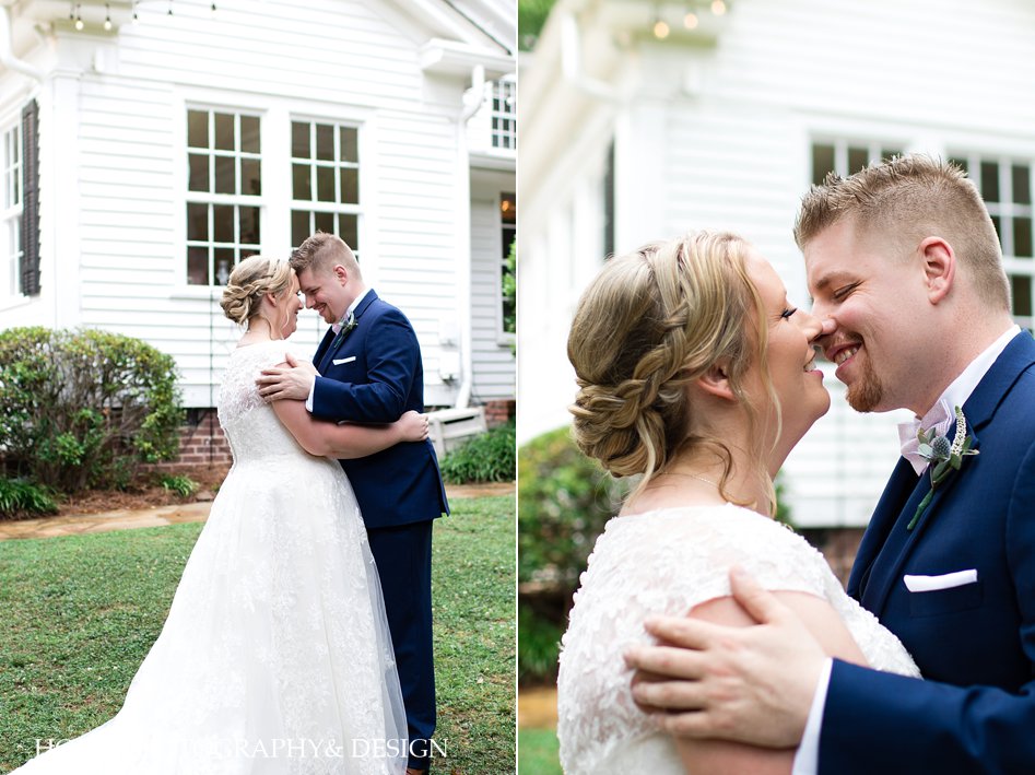 first look embracing photo pose ideas in front of venue forehead touching lace wedding dress bridal loose braid updo navy tuxedo horn photography and design