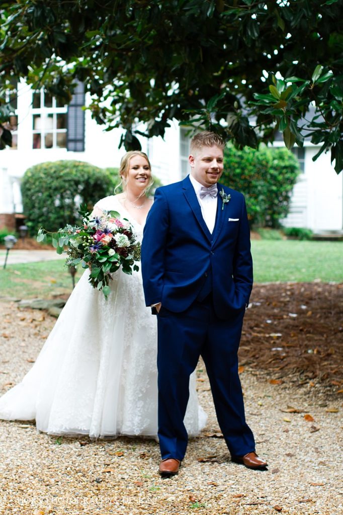 first look lace wedding dress vibrant floral bouquet navy tuxedo Atlanta GA horn photography and design