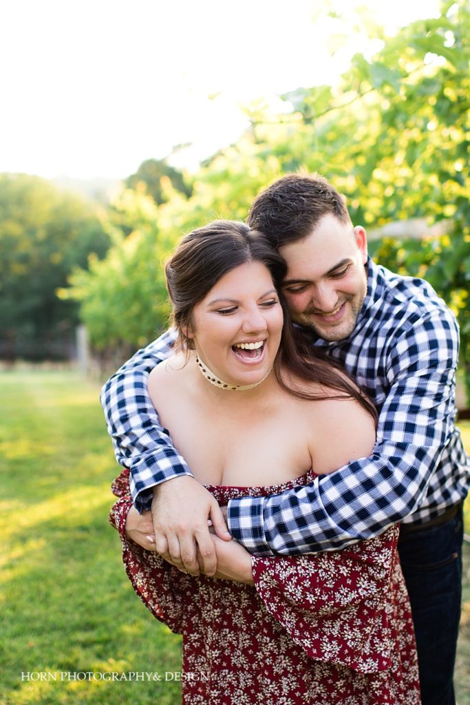 my everything engagement photo pose ideas embracing in vineyard North Georgia Mountain vineyards husband and wife photography team horn photography and design