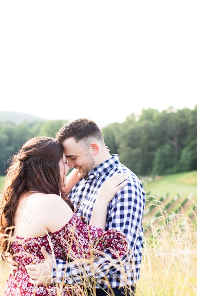 sweet embrace engagement photo pose floral dress blue checkered button down shirt touching noses and foreheads North Georgia horn photography and design