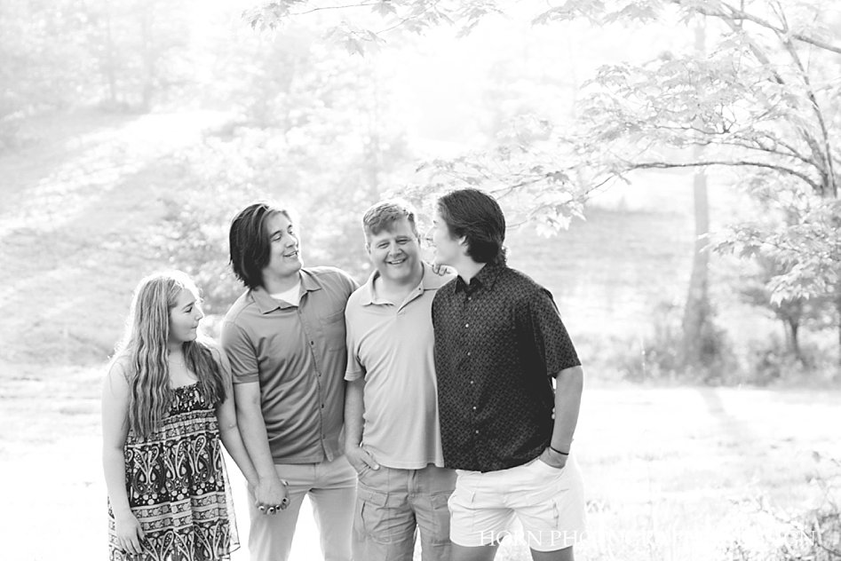 black and white inspiring family photo poses outdoor dad and children holding hands Forest Hills Georgia Mountain horn photography and design