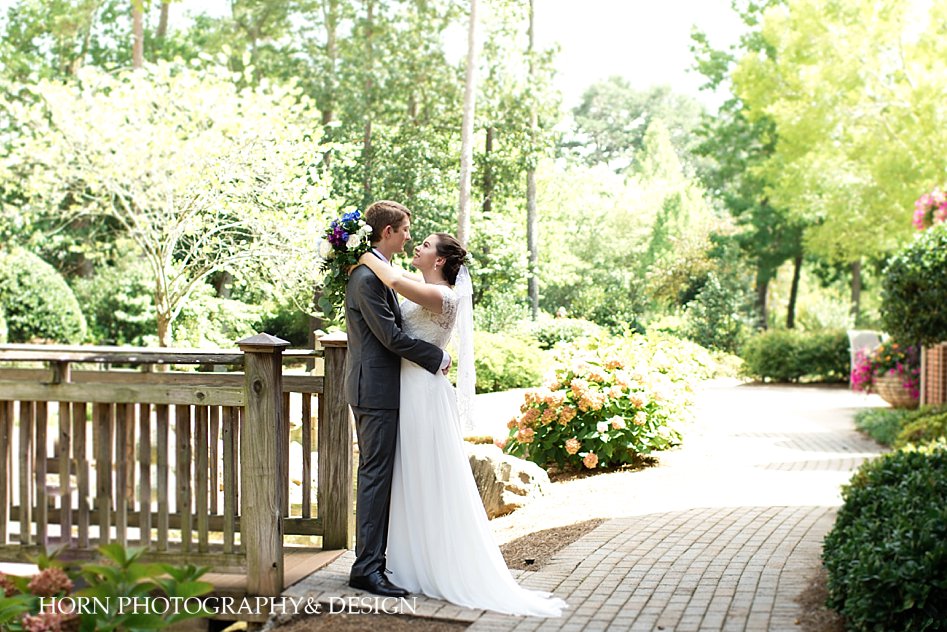 outdoor wedding in garden bride with bouquet and groom embracing Georgia horn photography and design