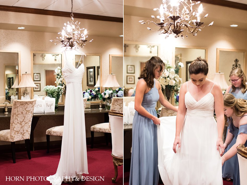 bridal suite wedding dress hanging from chandelier silhouette getting ready with friends horn photography and design