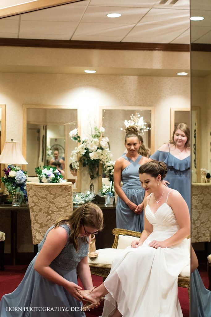 bridesmaids helping bride get ready in bridal suite Atlanta GA horn photography and design
