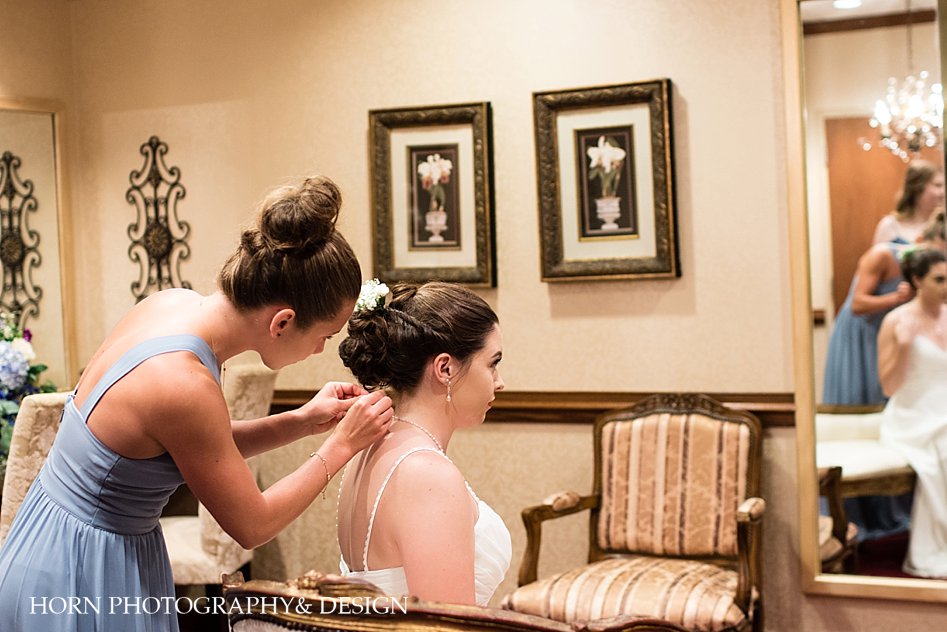 bridesmaid helping bride get ready twisted half updo bridesmaid bun updo St. Peter Chanel Roswell Georgia horn photography and design