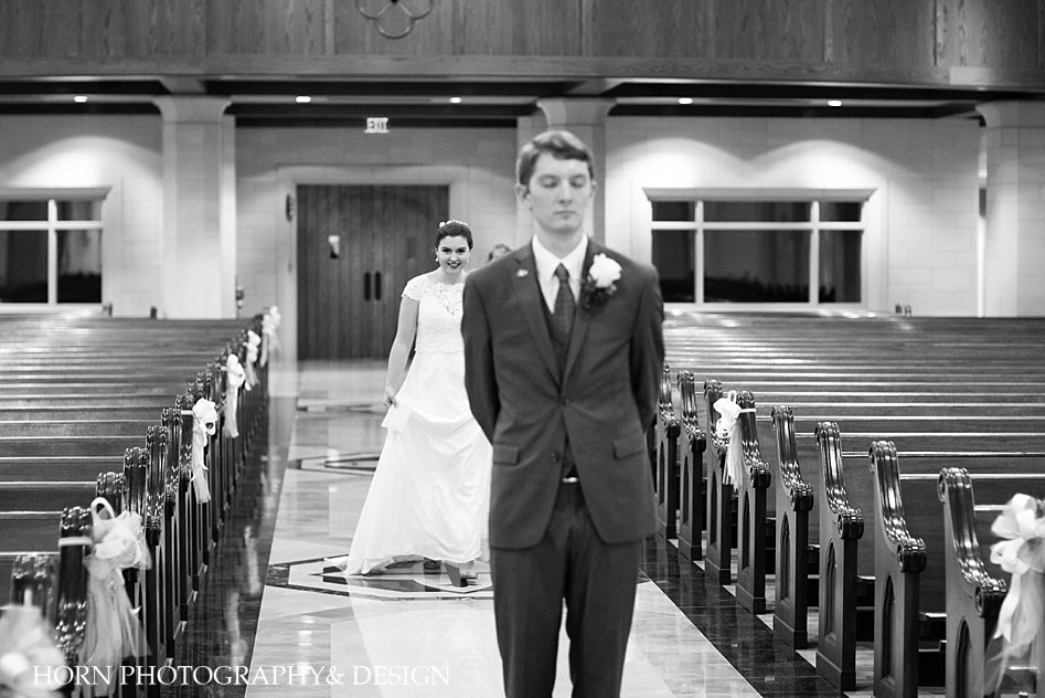 black ad white bride and groom first look inside church Catholic Wedding Southeast horn photography and design