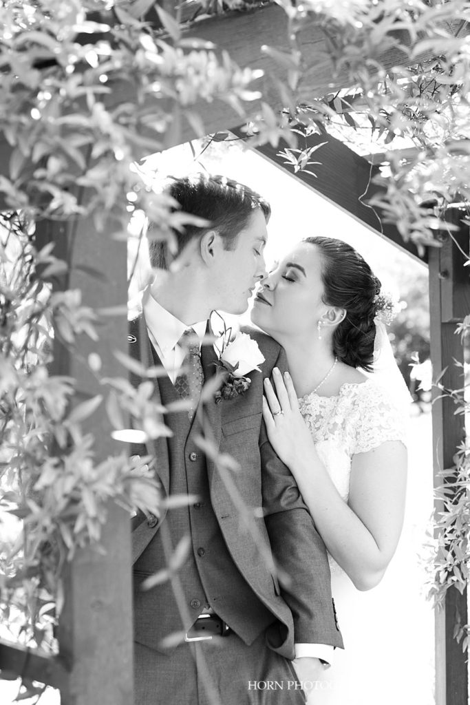 black and white wedding day husband and wife touching noses almost kissing photo pose ideas outdoor garden Metro Atlanta Georgia horn photography and design