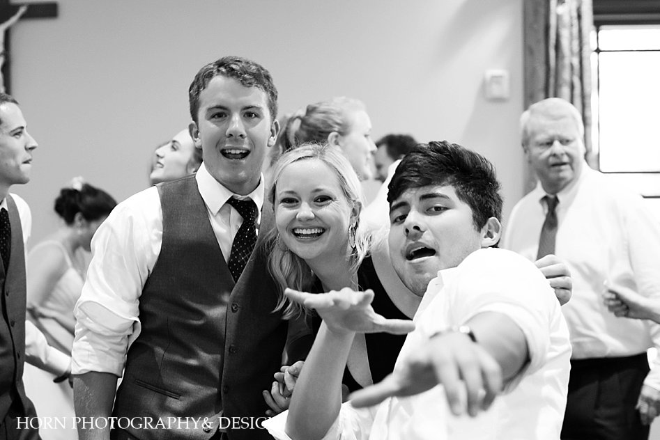 black and white wedding reception guests dancing husband and wife christian photography team horn photography and design