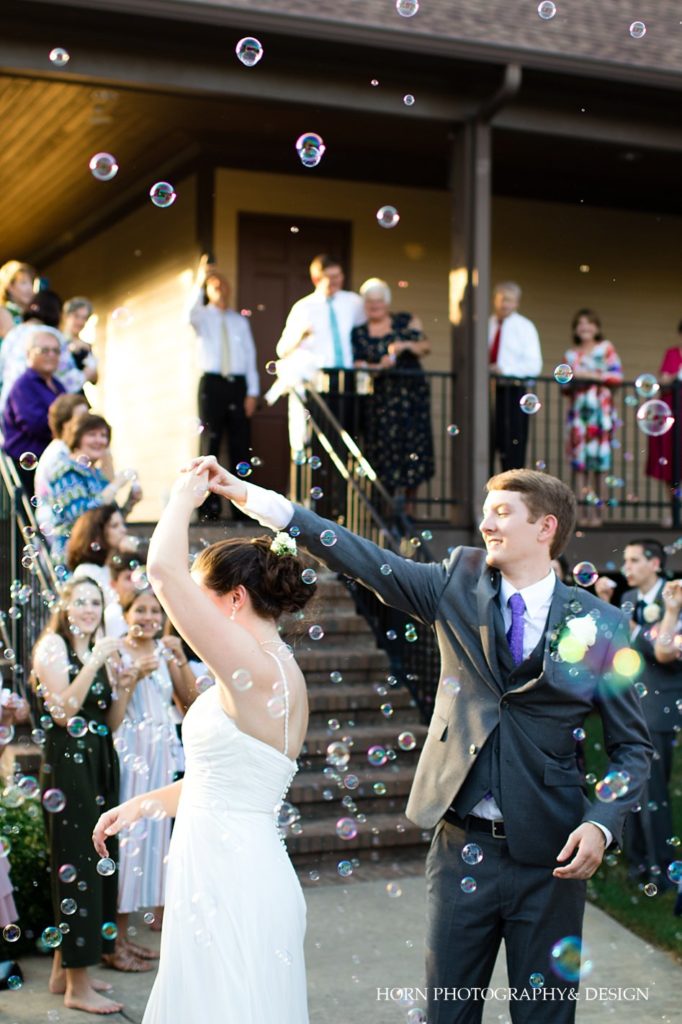 groom spinning bride as they leave reception in bubble parade outdoor summer  wedding Georgia horn photography and design