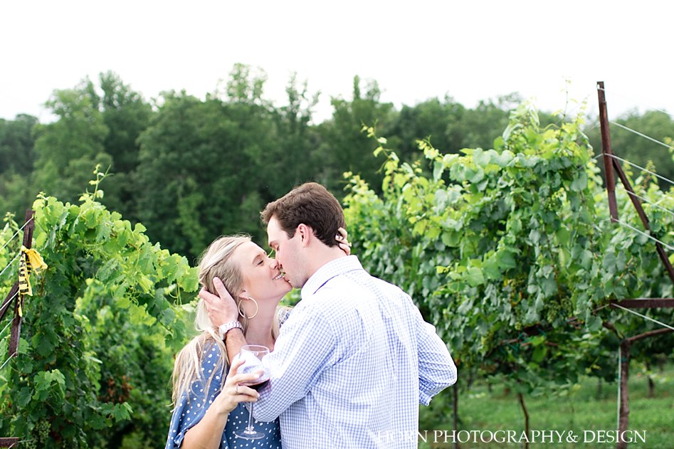 true love's kiss with a shot of wine candid vineyard engagement photo horn photography and design