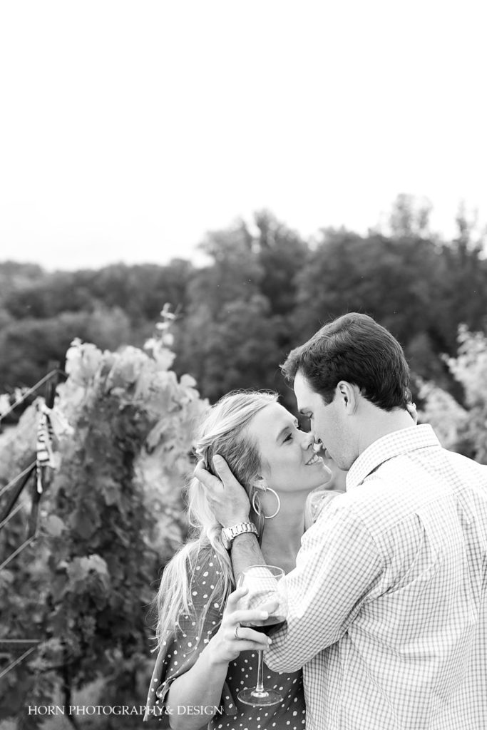 black and white engaged couple kissing in vineyard surprise proposal Southern charm horn photography and design
