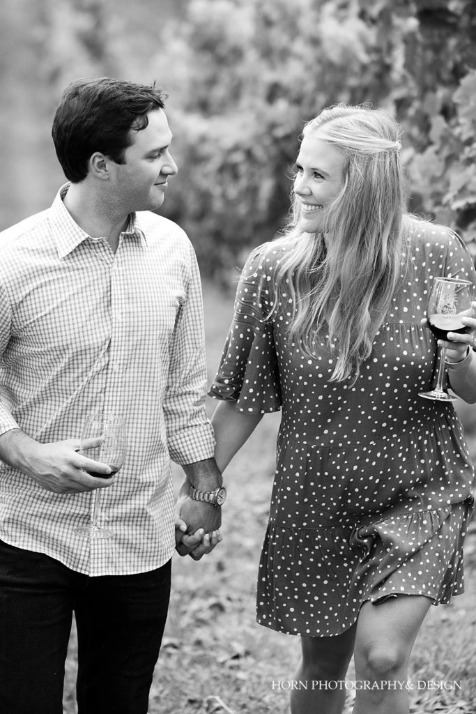 black and white holding hands in the vineyard engagement photo horn photography and design