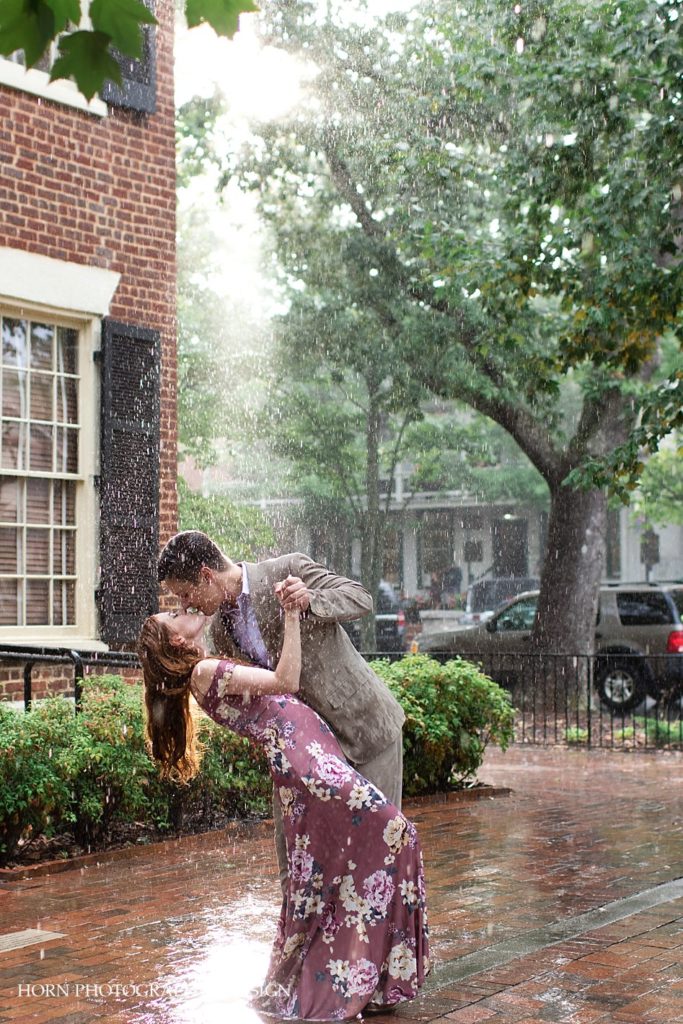 engaged couple kiss and dip dancing in the rain Dahlonega Georgia husband and wife team horn photography and design