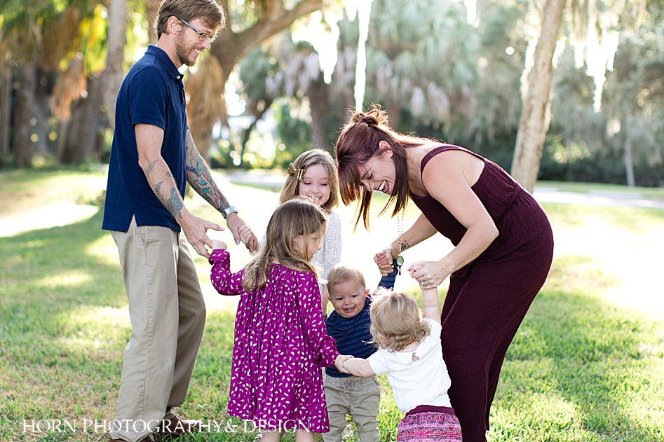 Family portrait playing ring around the Rosie bright colorful twins horn photography and design