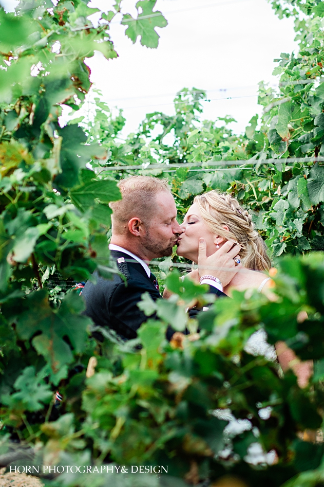 Scottish vineyard wedding kaya winery horn photography and design couple kissing in the vines