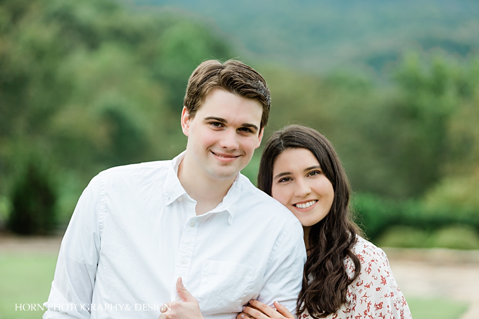 closeup girl and guy pose blue mountain vineyards engagement