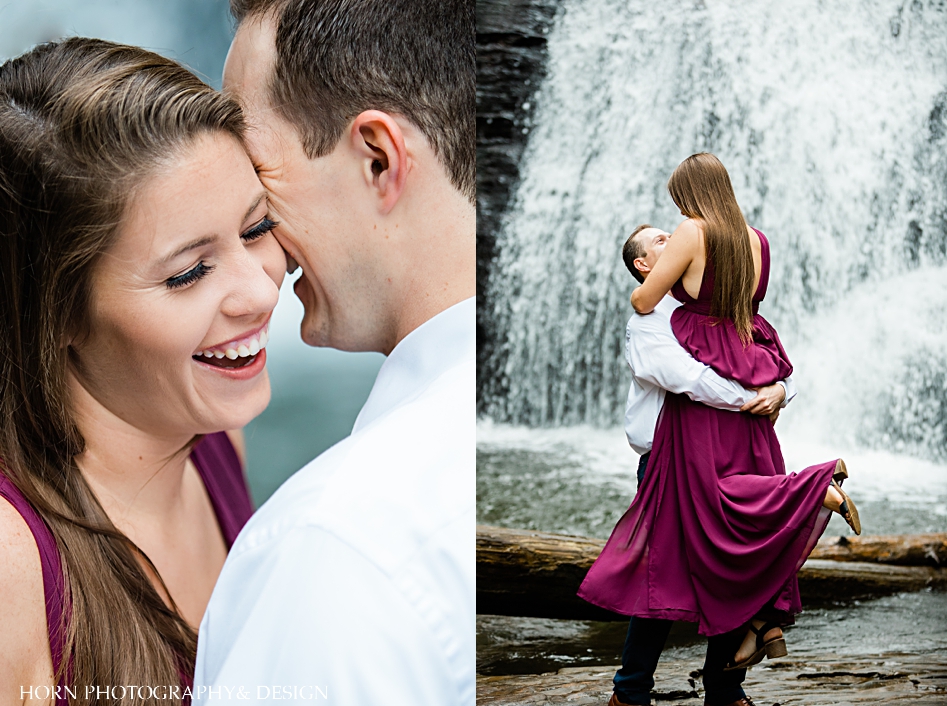 groom picks up bride for engagement shoot in front of waterfall