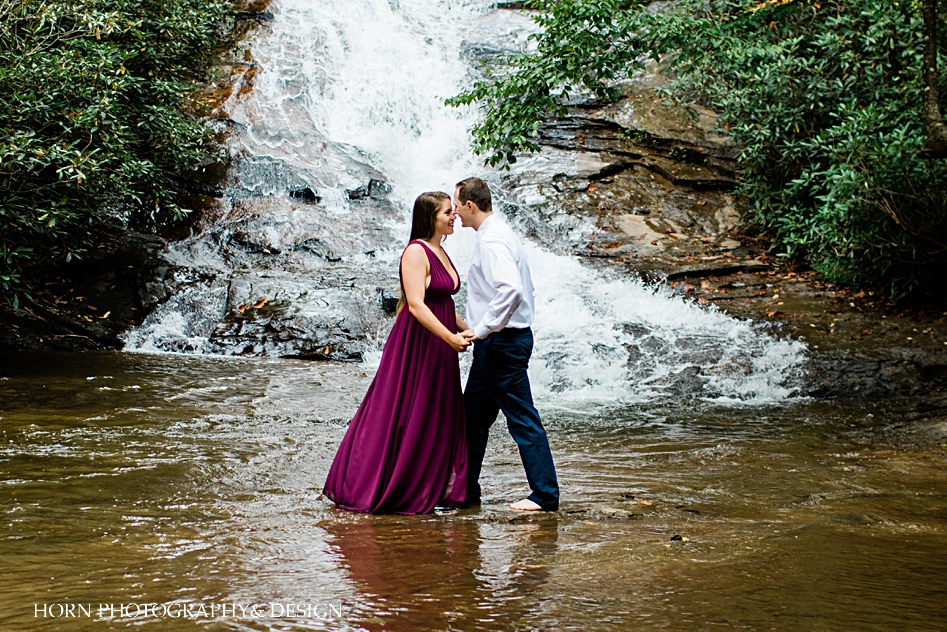 Appalachian Waterfall Engagement session standing in front of waterfall in the water kissing