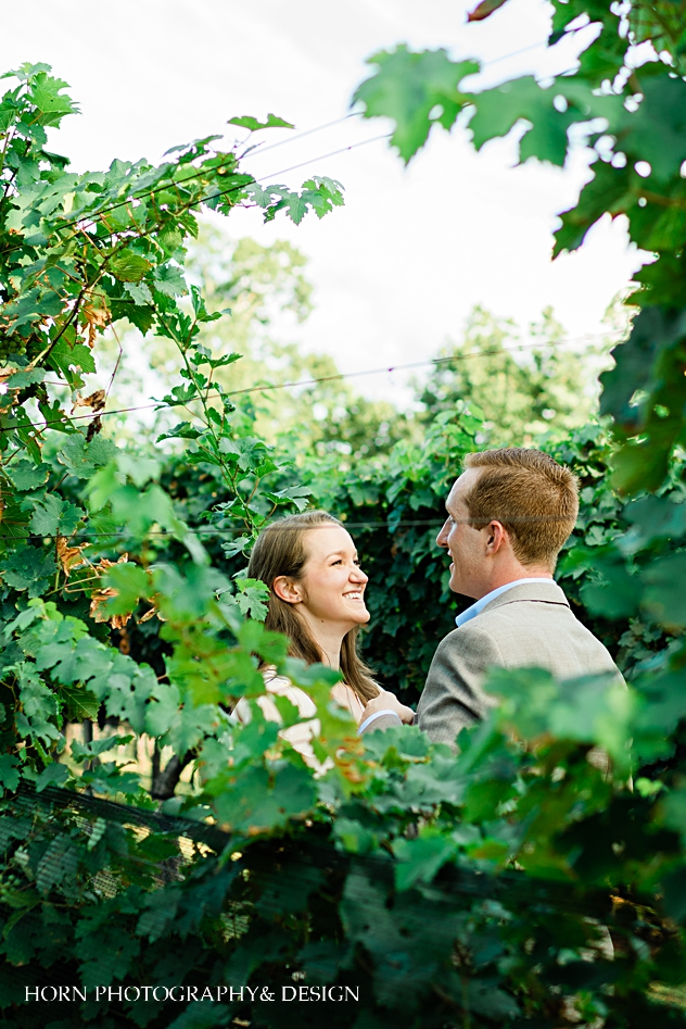 couple poses through the vines dahlonega ga Atlanta wedding photographers