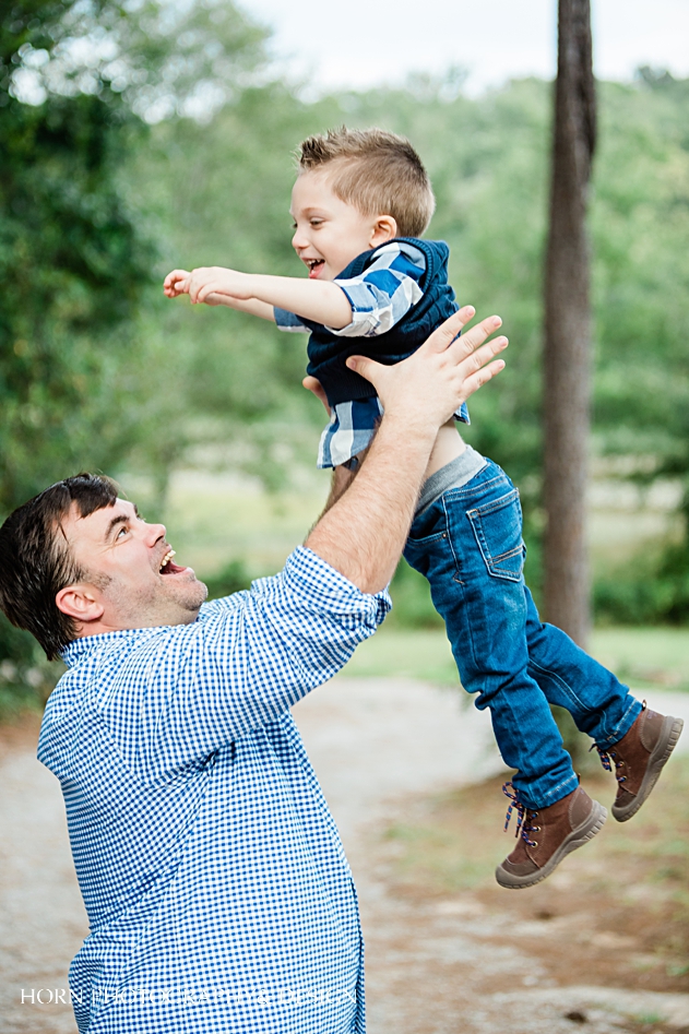 dad tosses son in air Starr's Mill Family session Georgia family lifestyle photographers