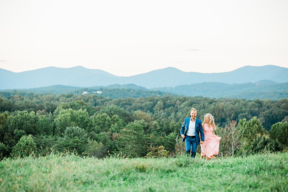 blue mountain range dahlonega photography shoot anniversary blue suit pink dress running up hill together