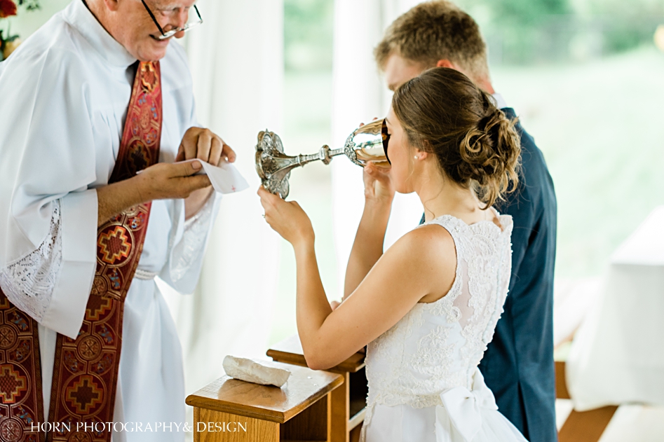 couple receiving communion Horn photography and design St. Anna Church wedding