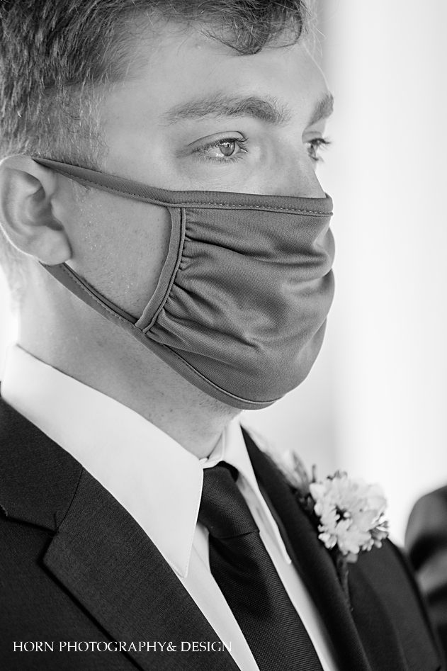 covid mask on groom