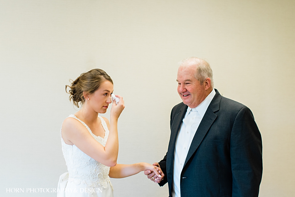 dad's first look bride wiping a tear