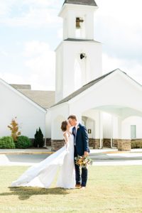 st Anna Catholic Church Monroe ga wedding couple kissing in front of church