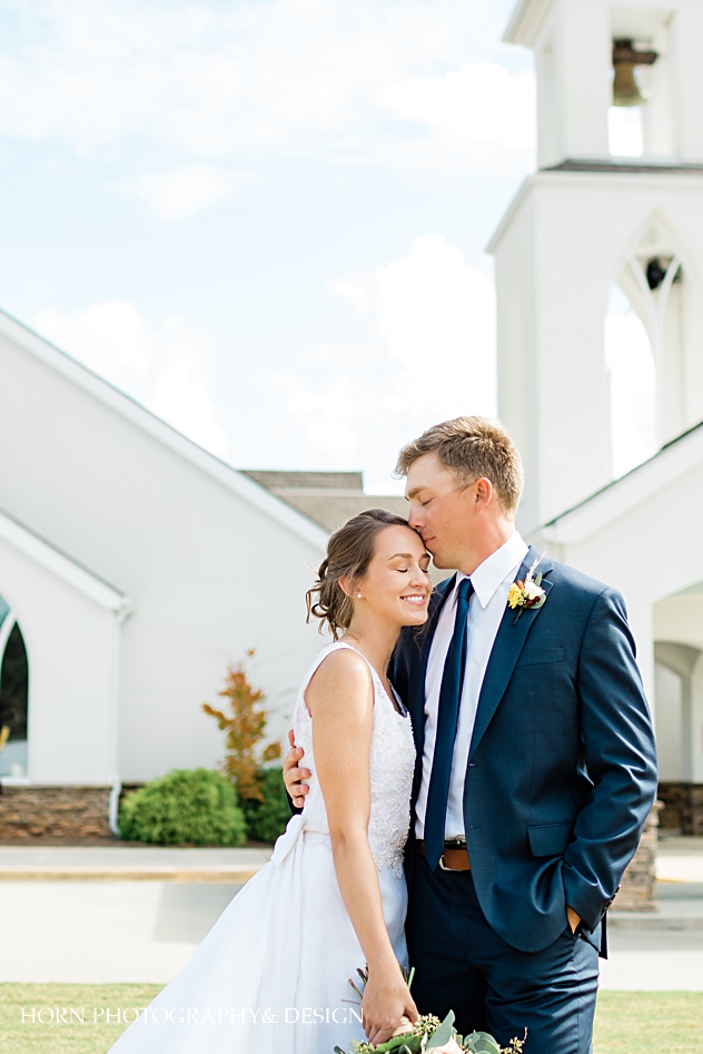 st Anna Catholic Church Monroe ga wedding  couple kissing in front of church