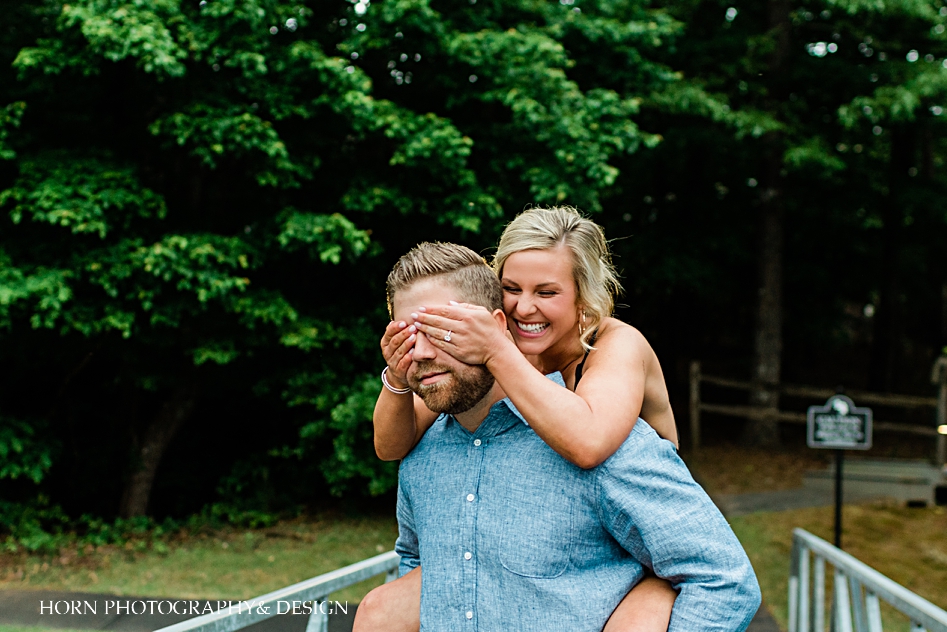 Bride covers groom's eyes engagement session chestatee lake Lanier