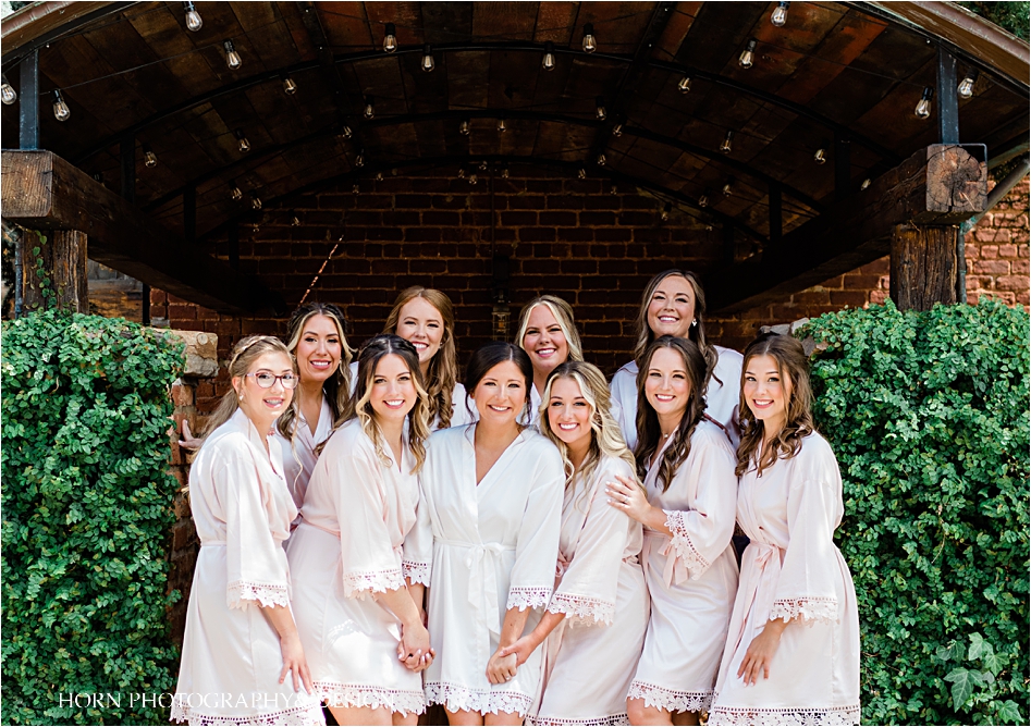 Bridal party in robes  Cigar Warehouse Wedding Horn photography and design